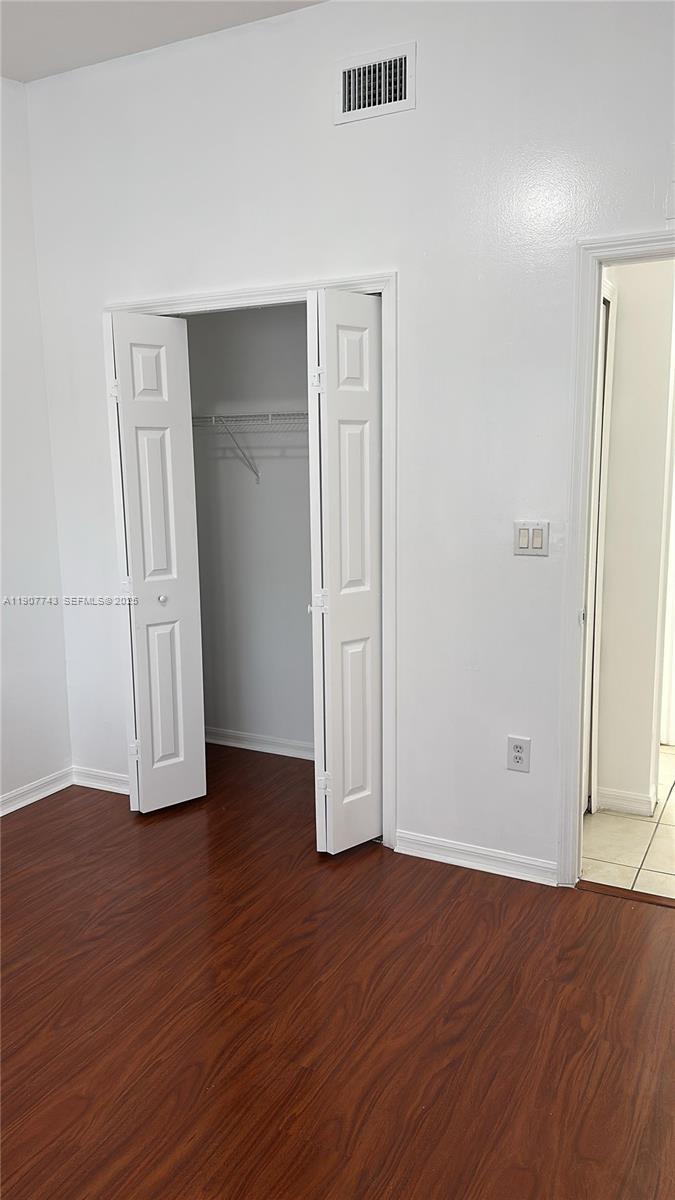 2910 Southeast 12th Road, Unit 20429 Homestead, FL 33035 - Photo 19 of 25 an empty room with wooden floor and closet