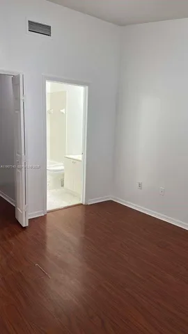 a bathroom with a sink and mirror with toilet