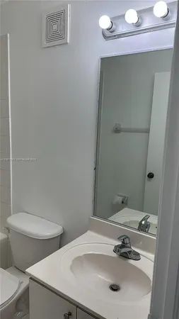 a bathroom with a sink a toilet and a bathtub