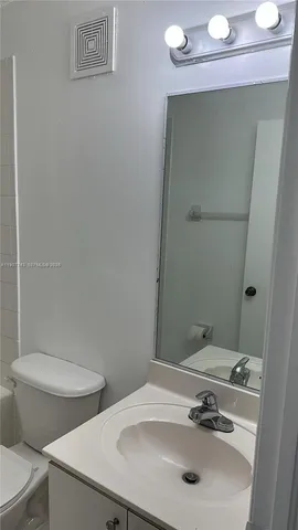 a bathroom with a sink a toilet and a bathtub