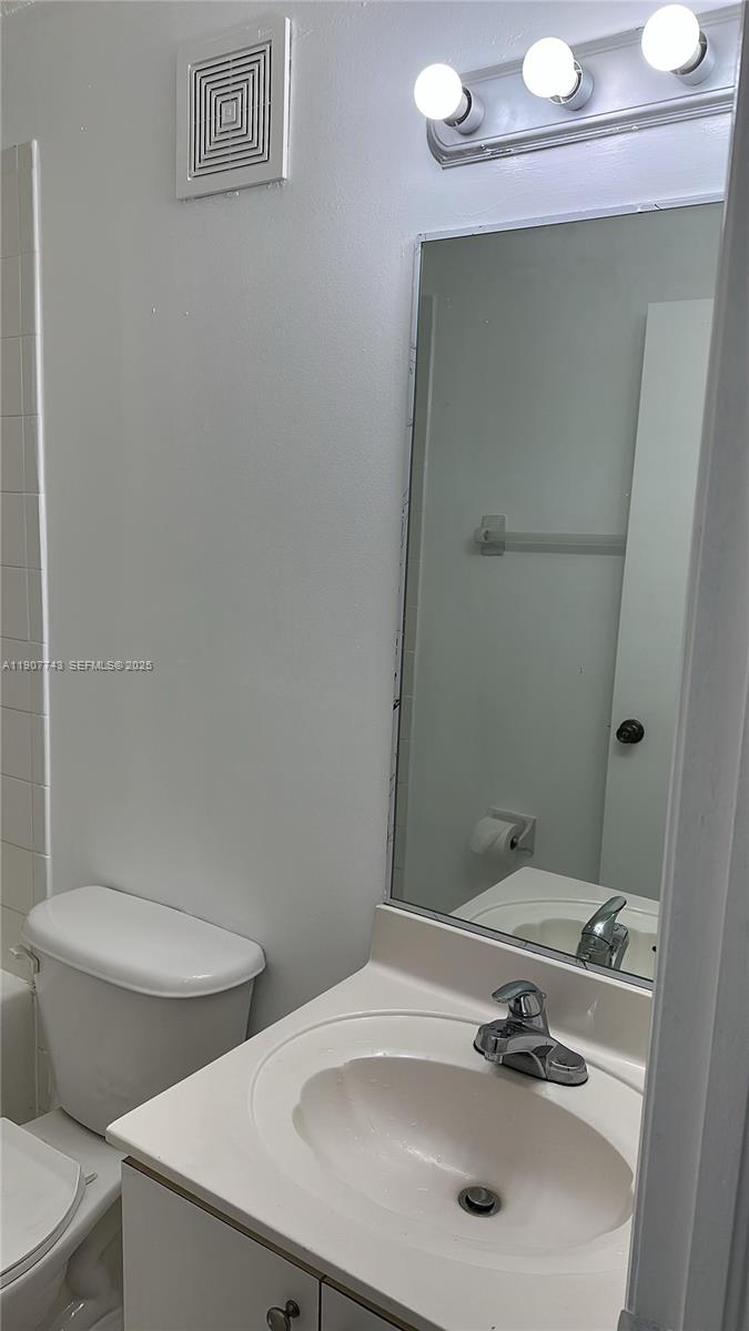 2910 Southeast 12th Road, Unit 20429 Homestead, FL 33035 - Photo 22 of 25 a bathroom with a sink and mirror with toilet