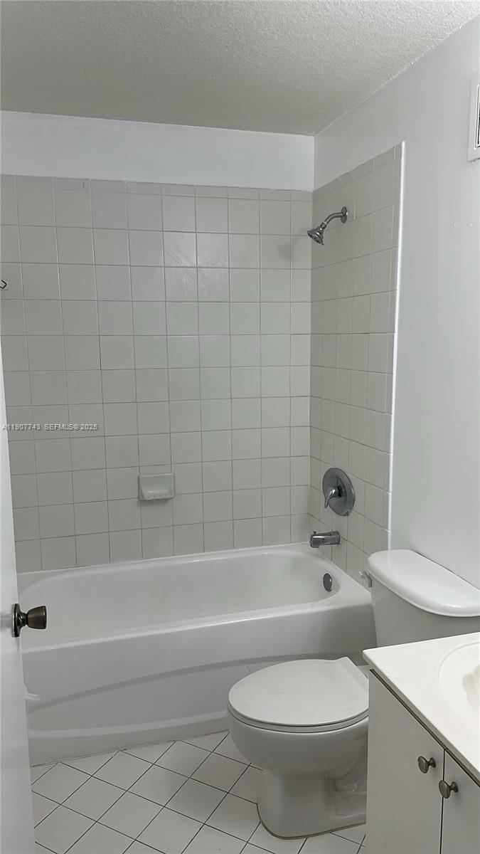 2910 Southeast 12th Road, Unit 20429 Homestead, FL 33035 - Photo 25 of 25 a white toilet and tub sitting next to a bathroom sink