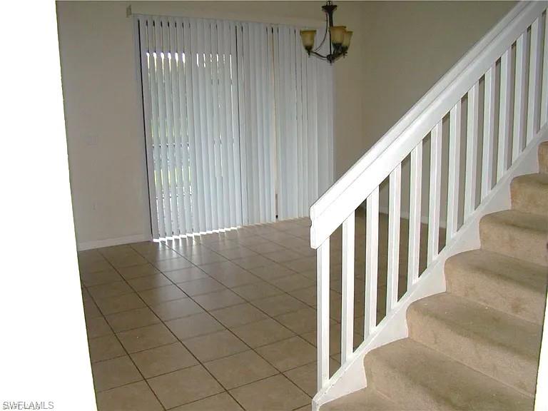 7423 Bristol Circle Naples, FL 34120 - Photo 3 of 6 Stairway featuring tile patterned flooring and baseboards