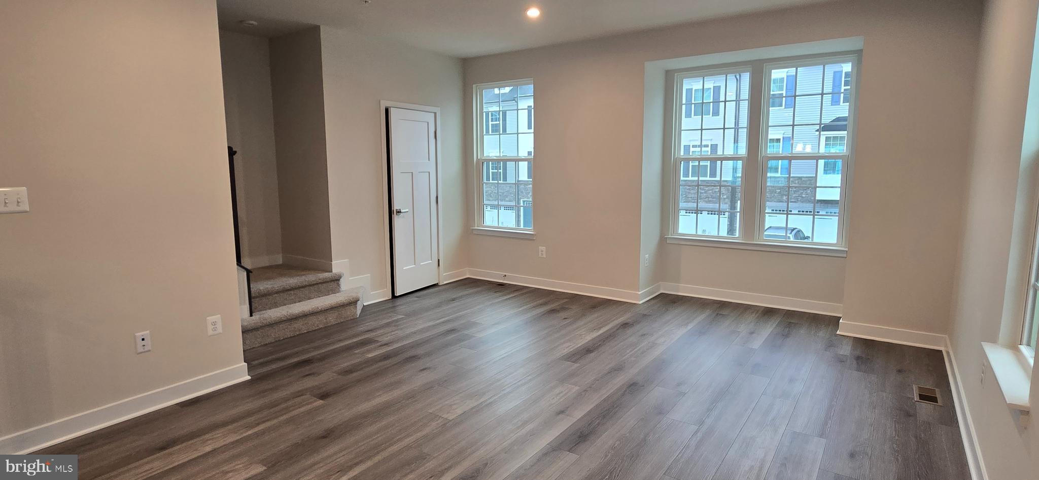 357 Marquis Street Frederick, MD 21702 - Photo 12 of 23 an empty room with wooden floor and windows