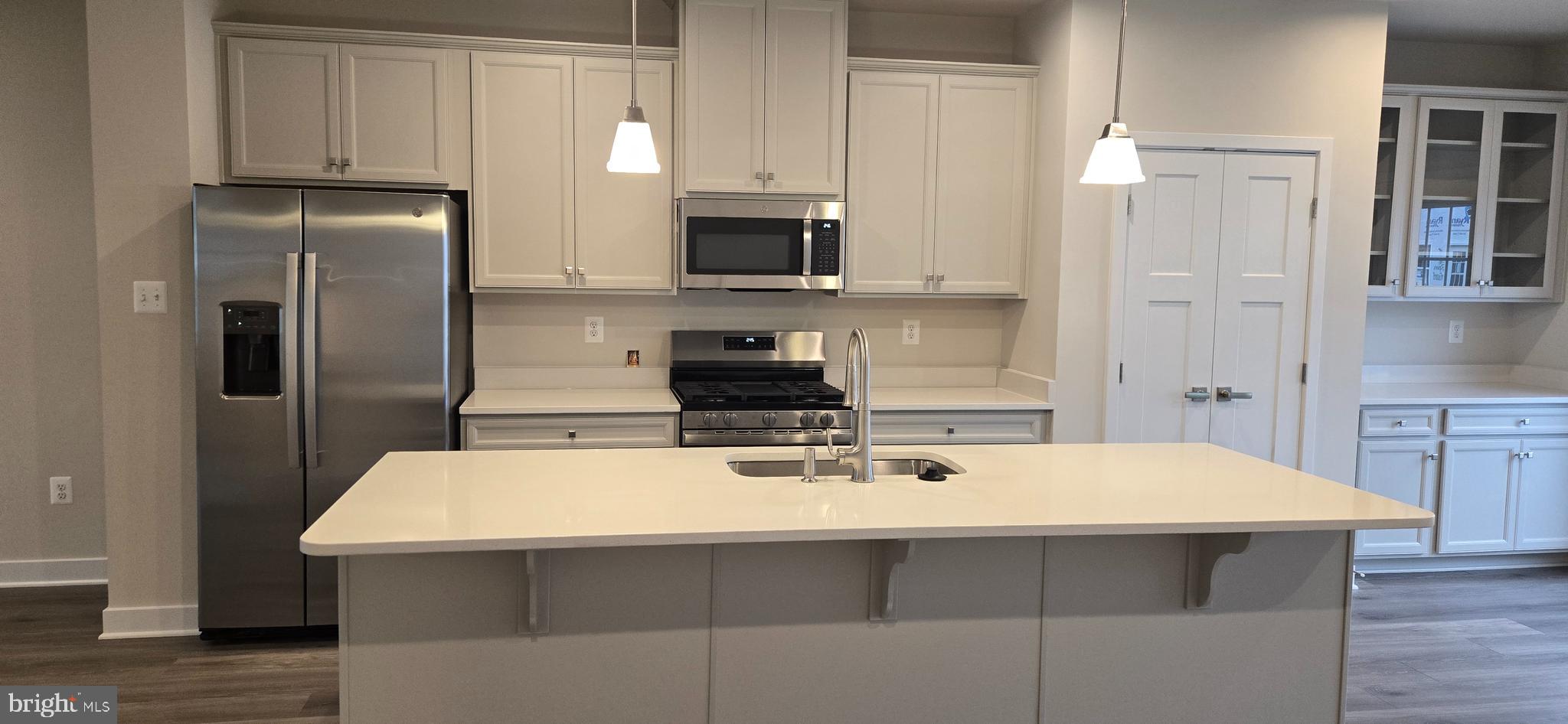 357 Marquis Street Frederick, MD 21702 - Photo 6 of 23 a kitchen with a sink a microwave a refrigerator and cabinets