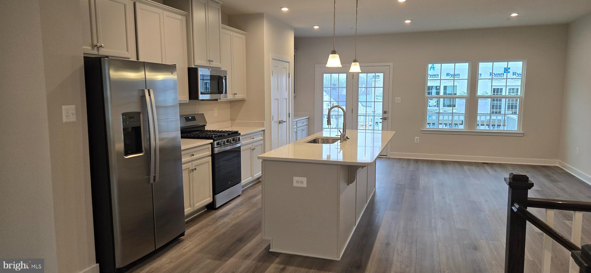 357 Marquis Street Frederick, MD 21702 - Photo 7 of 23 a kitchen with stainless steel appliances granite countertop a refrigerator a stove and a sink with wooden floor
