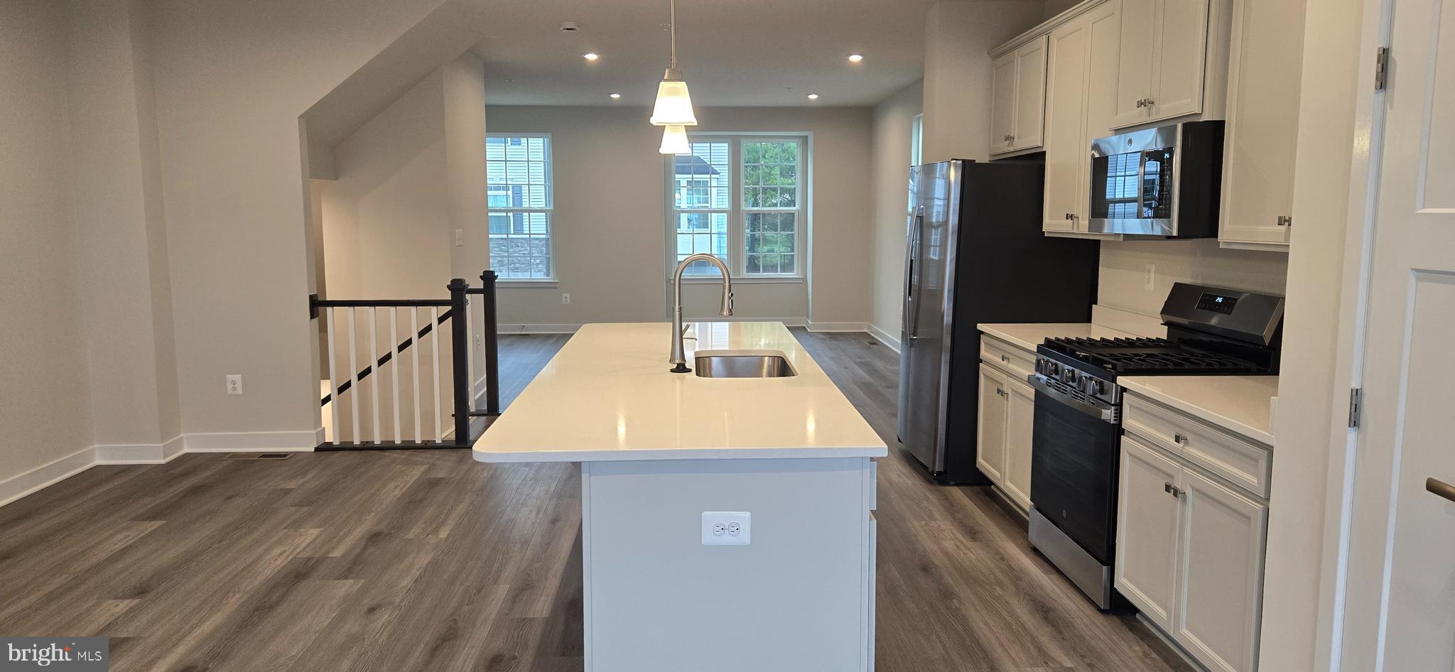 357 Marquis Street Frederick, MD 21702 - Photo 8 of 23 a kitchen with stainless steel appliances granite countertop a refrigerator a stove and a sink with wooden floor