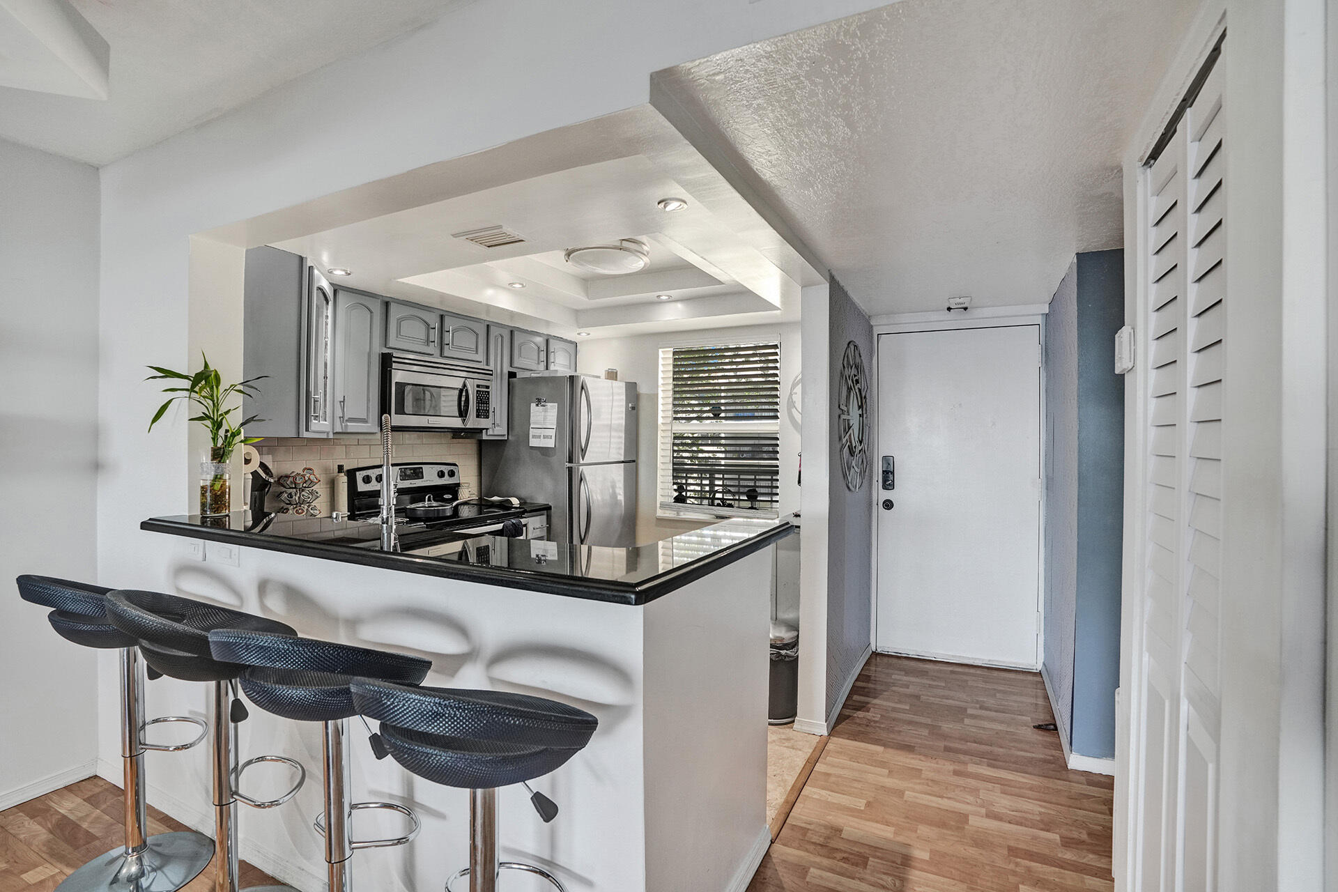 6193 Rock Island Road, Unit 405 Tamarac, FL 33319 - Photo 26 of 42 a kitchen with stainless steel appliances kitchen island granite countertop a refrigerator and a stove top oven
