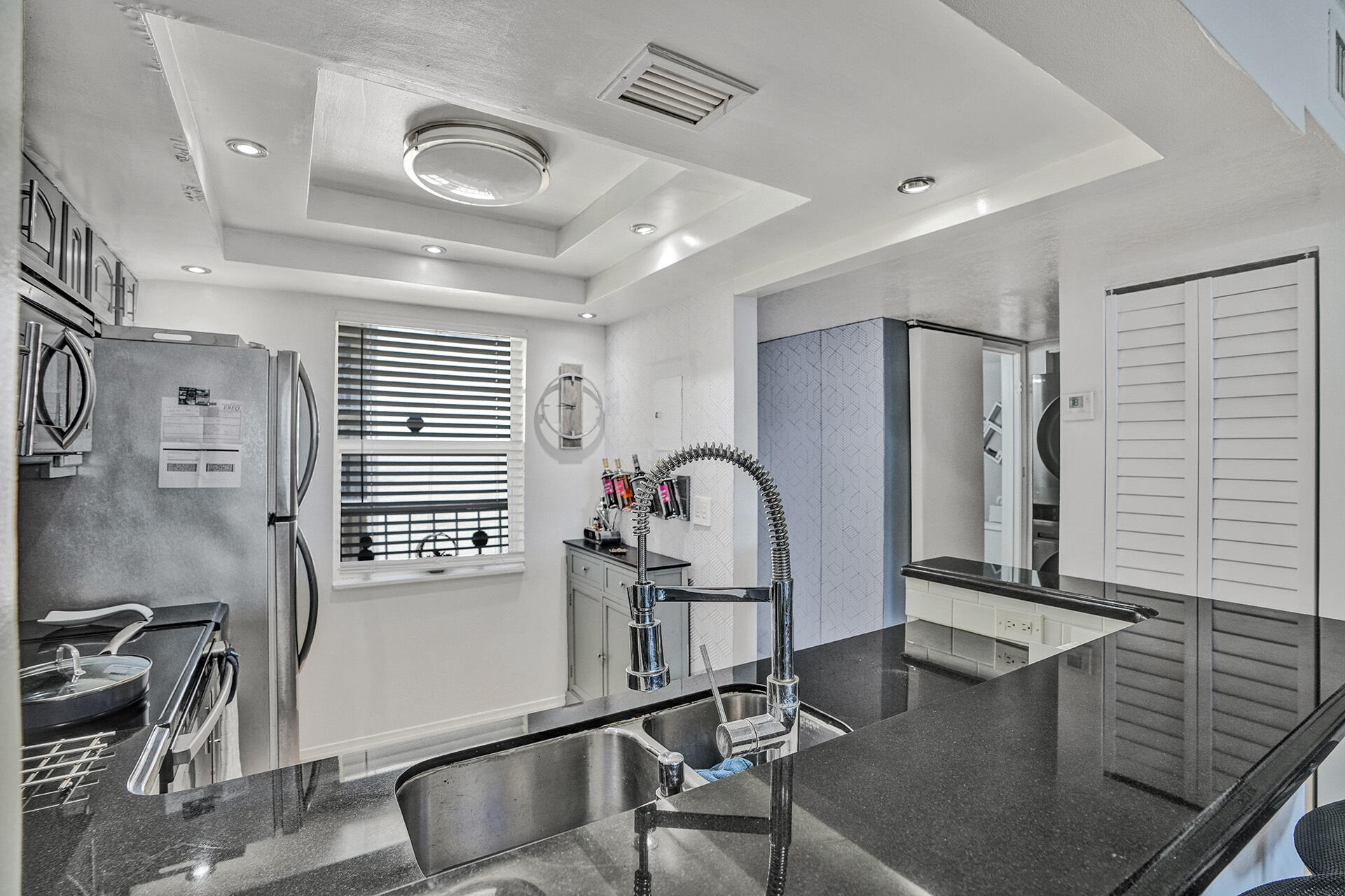 6193 Rock Island Road, Unit 405 Tamarac, FL 33319 - Photo 28 of 42 a kitchen with stainless steel appliances granite countertop sink refrigerator and stove