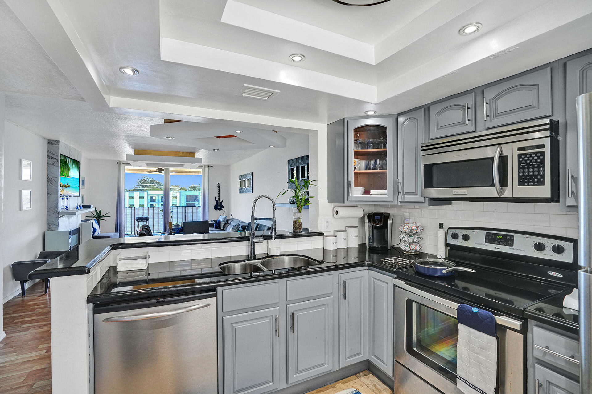 6193 Rock Island Road, Unit 405 Tamarac, FL 33319 - Photo 30 of 42 a kitchen with stainless steel appliances granite countertop a stove and a sink