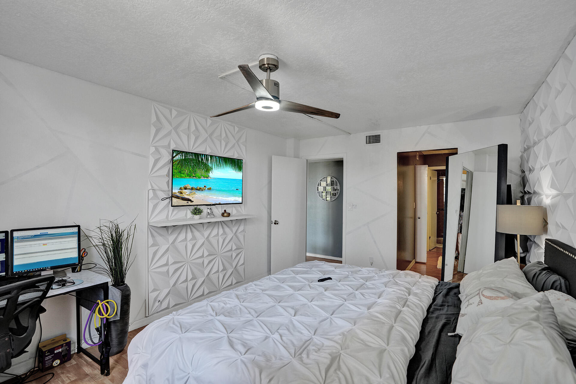 6193 Rock Island Road, Unit 405 Tamarac, FL 33319 - Photo 3 of 42 a bedroom with a bed and a flat screen tv