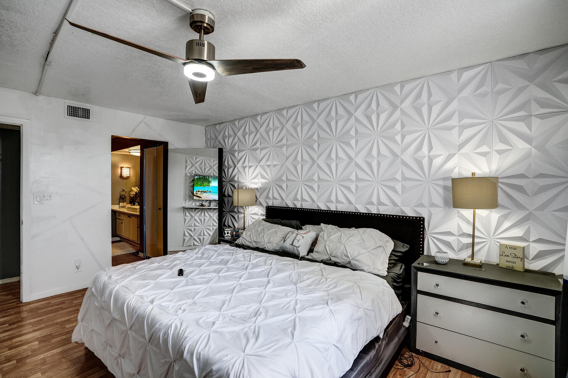 6193 Rock Island Road, Unit 405 Tamarac, FL 33319 - Photo 34 of 42 a bedroom with a large bed and a flat tv screen on dresser
