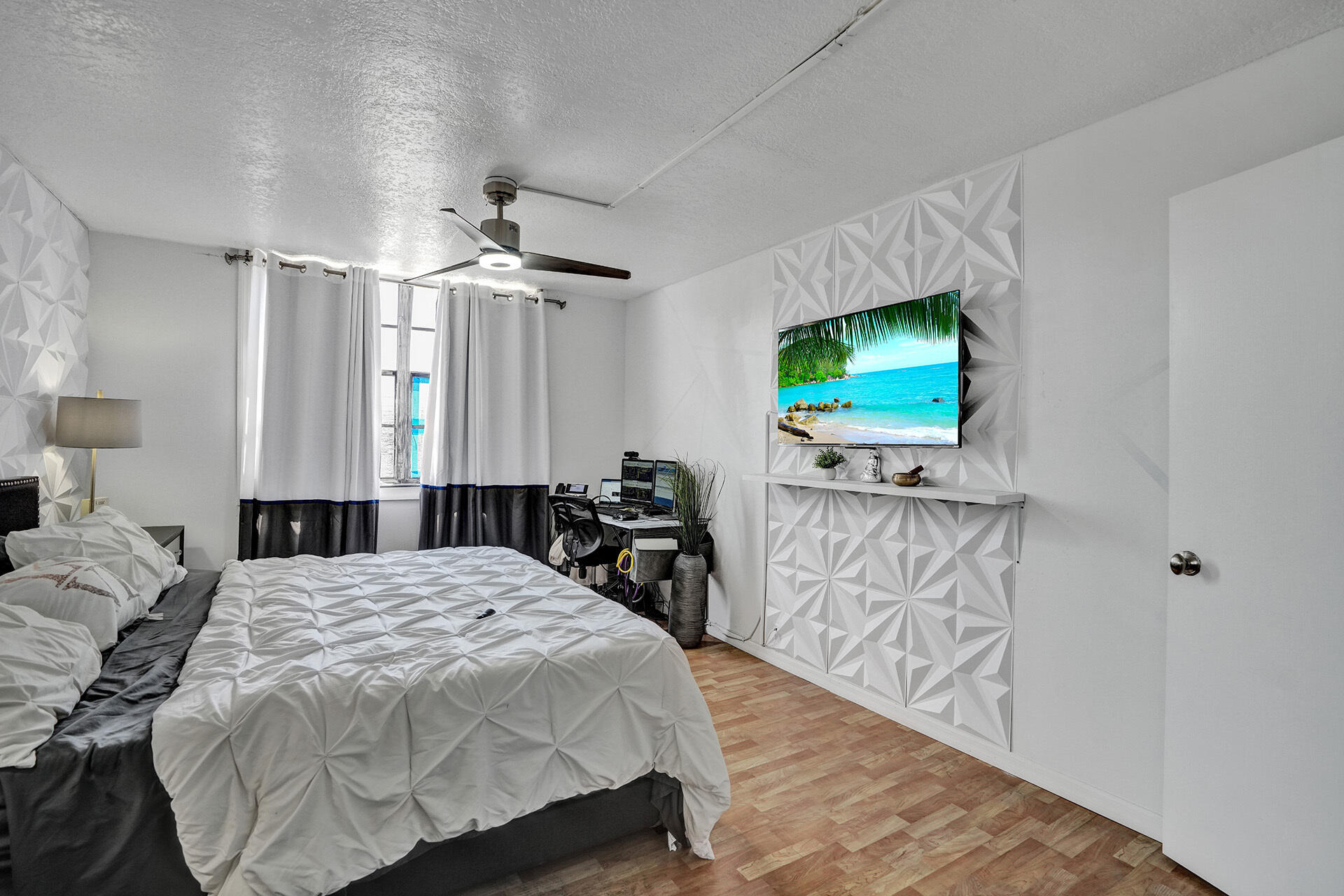 6193 Rock Island Road, Unit 405 Tamarac, FL 33319 - Photo 35 of 42 a bedroom with a bed and a flat tv screen on a dresser