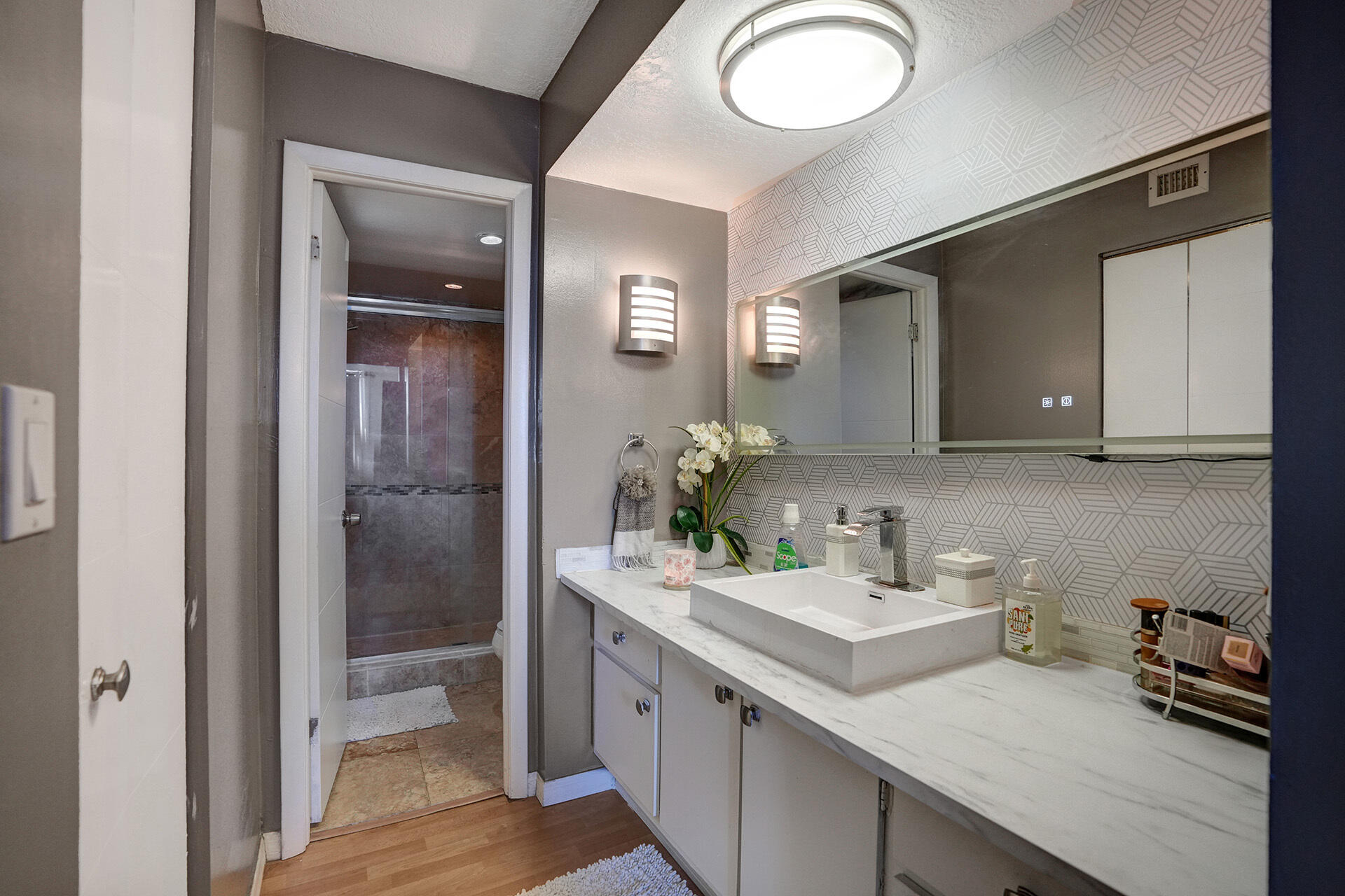 6193 Rock Island Road, Unit 405 Tamarac, FL 33319 - Photo 36 of 42 a bathroom with a sink and a mirror