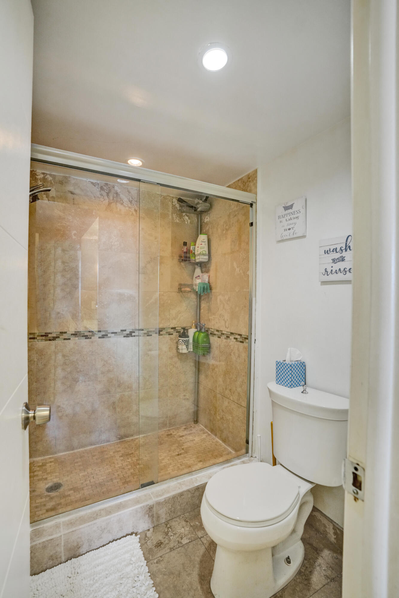 6193 Rock Island Road, Unit 405 Tamarac, FL 33319 - Photo 38 of 42 a bathroom with a shower a toilet and a sink