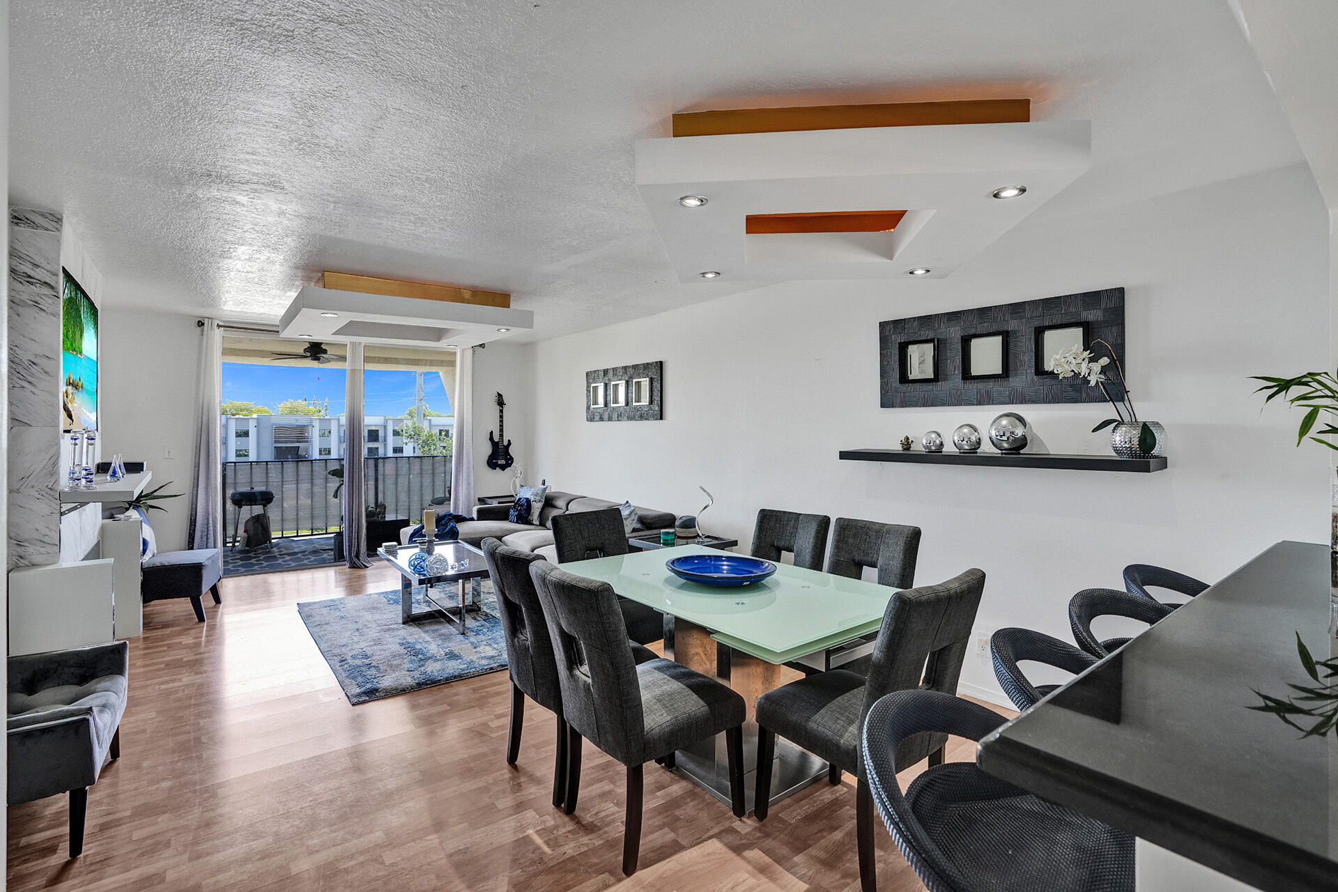 6193 Rock Island Road, Unit 405 Tamarac, FL 33319 - Photo 7 of 42 a view of a dining room and livingroom with furniture wooden floor and a rug
