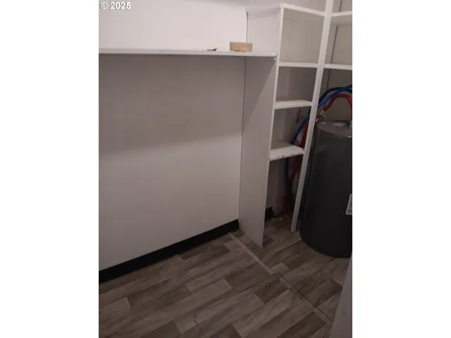 a room with wooden cabinets and a window