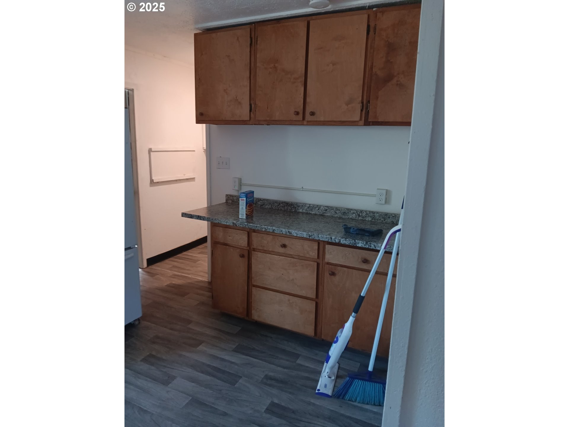 210 Jefferson Street West Huntington, OR 97907 - Photo 13 of 14 a room with wooden cabinets and a window