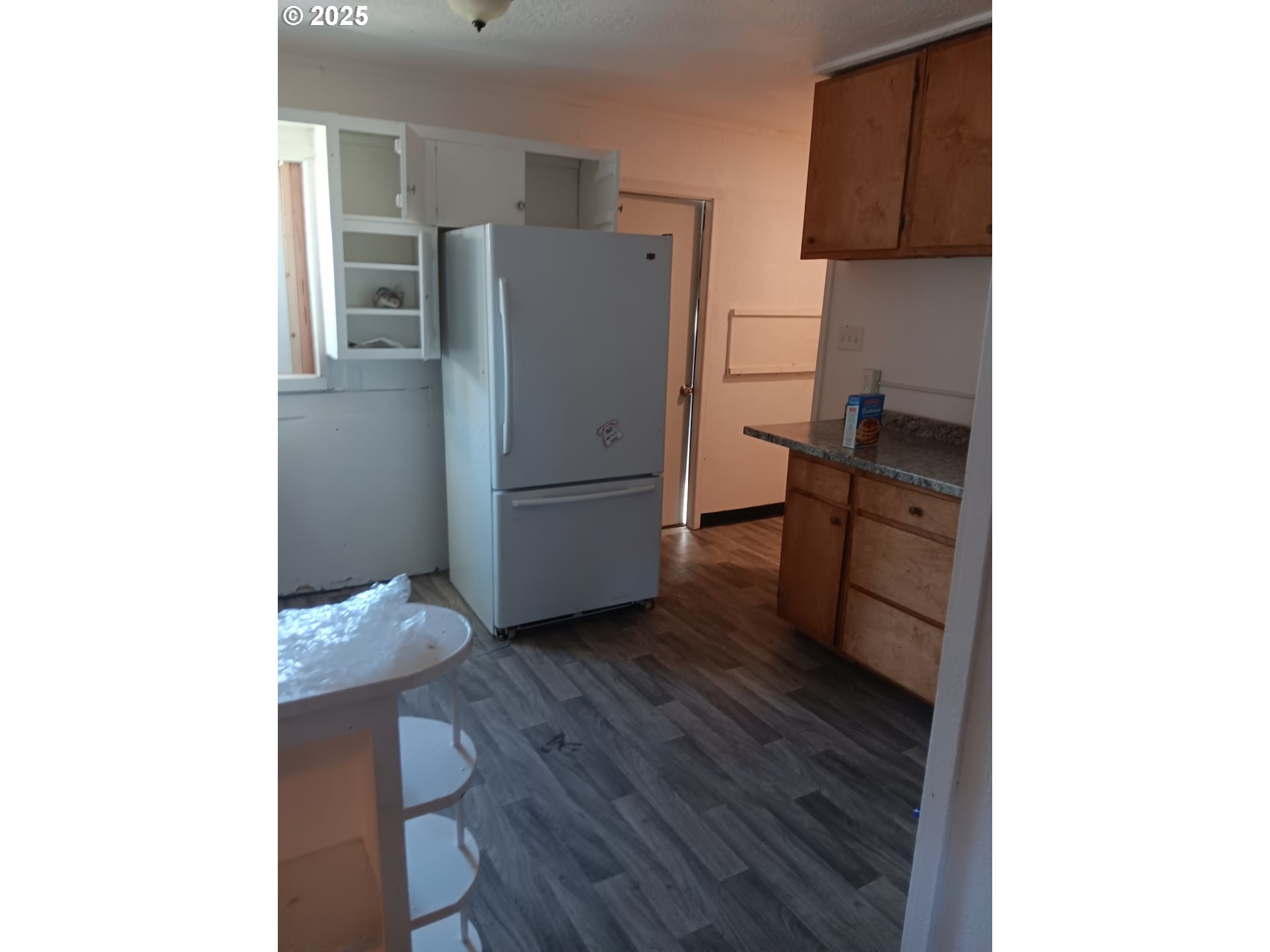 210 Jefferson Street West Huntington, OR 97907 - Photo 14 of 14 a kitchen with a refrigerator and wooden floor