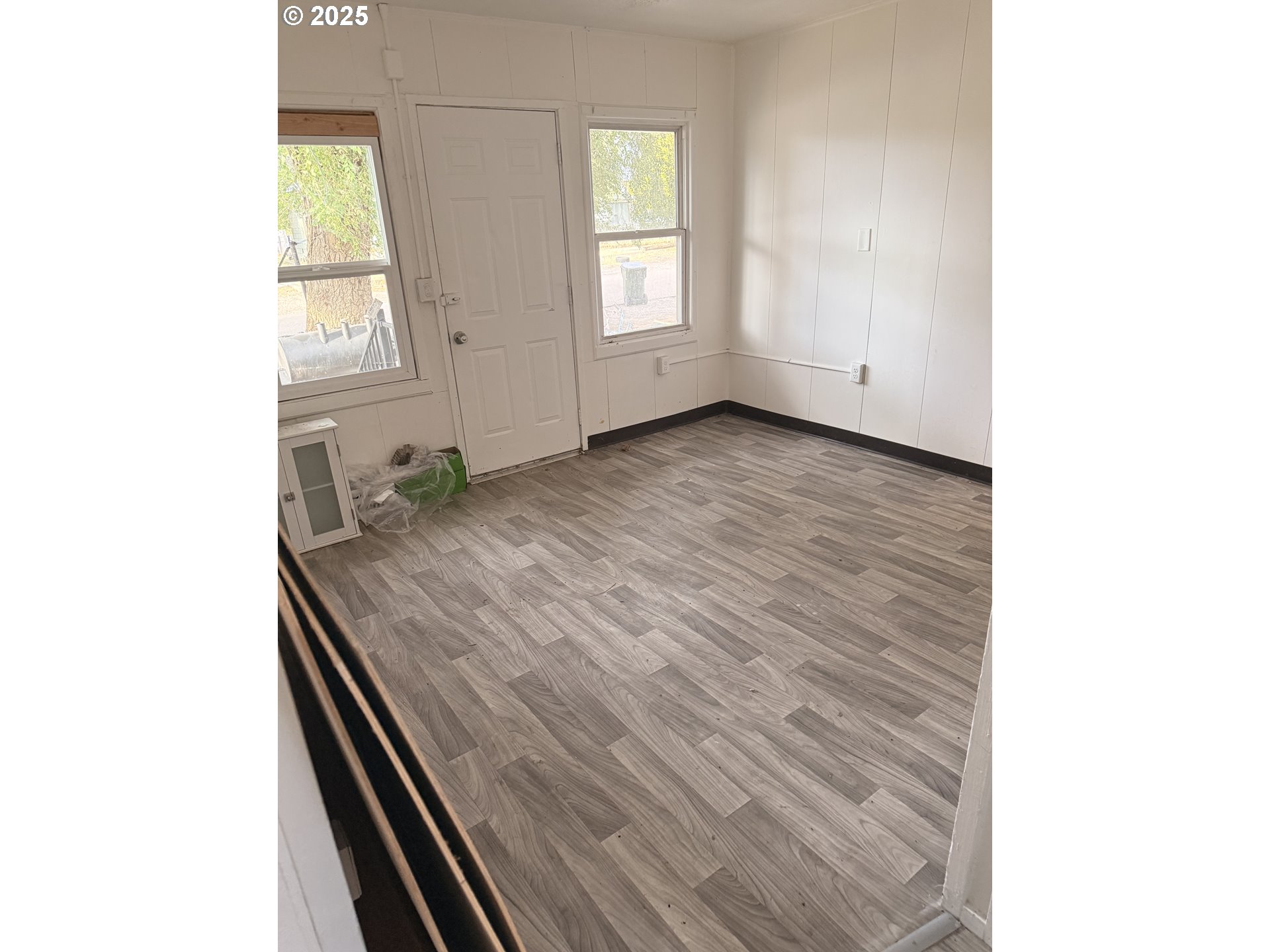 210 Jefferson Street West Huntington, OR 97907 - Photo 7 of 14 a view of an empty room with wooden floor and a window