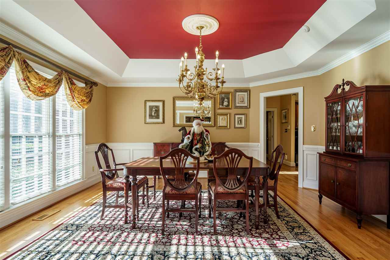 1028 Mersey Lane Raleigh, NC 27615 - Photo 4 of 30 Dining Room with tray ceiling, crown mould, wainscot and hardwood floors. Dining Room