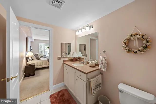 a en suite bathroom with a toilet sink and mirror
