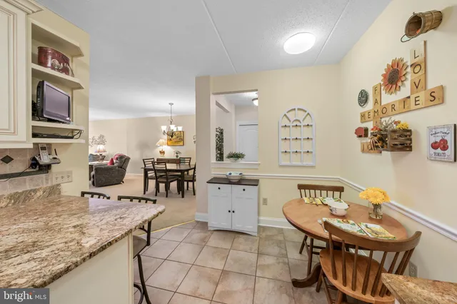 a kitchen with a sink a stove a dining table and chairs