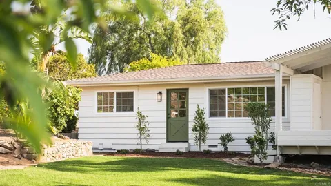 a kitchen with stainless steel appliances kitchen island granite countertop a sink a stove and a refrigerator