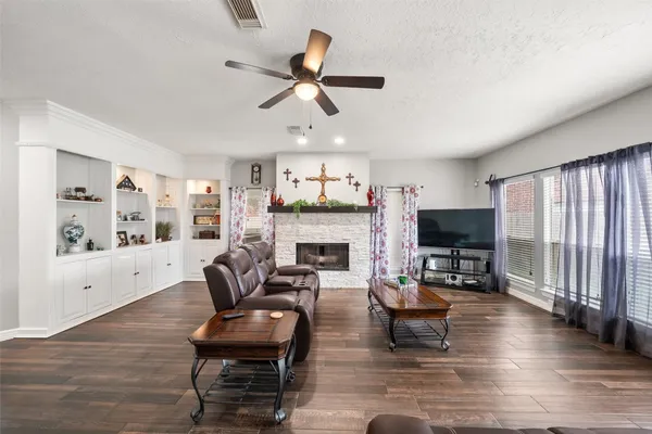 a living room with furniture a fireplace and a flat screen tv