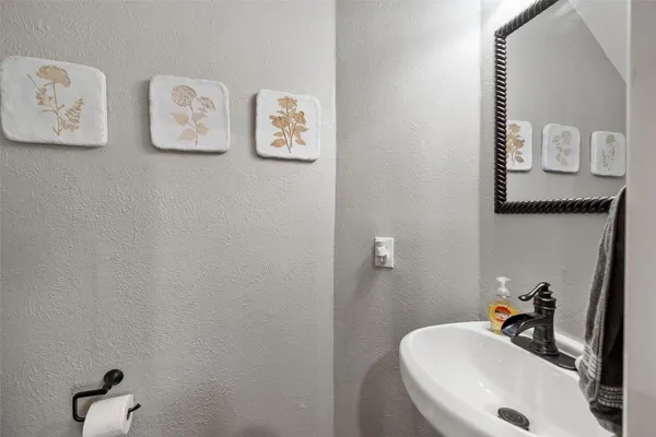a bathroom with a sink mirror and vanity