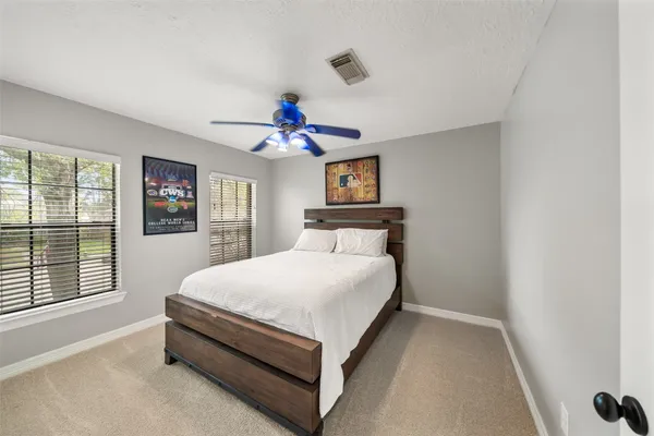 a bed room with a bed and a chandelier