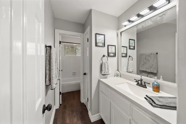 a bathroom with a double vanity sink a mirror and shower