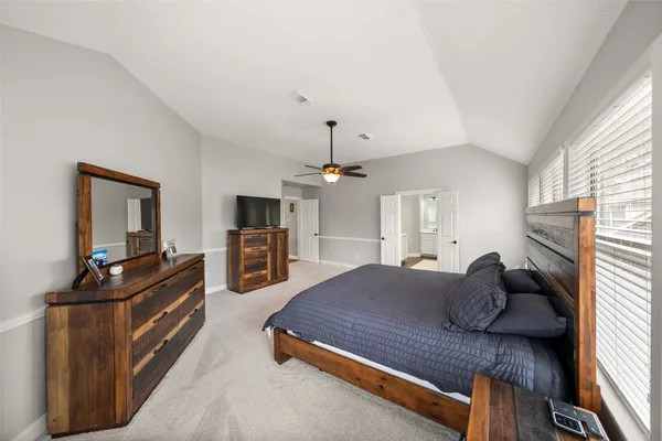 a bedroom with a bed kitchen view and a window