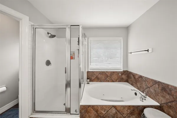 a bathroom with a tub a sink and a shower