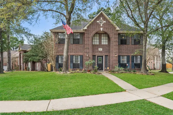a front view of a house with a yard and porch