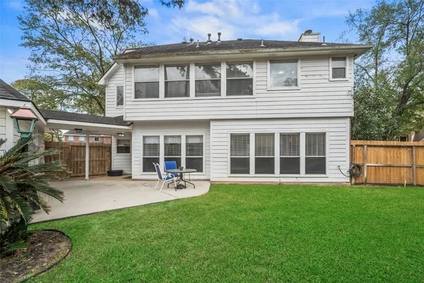 a front view of a house with a yard and outdoor seating