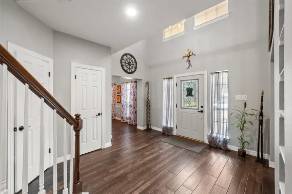 a dining room with furniture and wooden floor