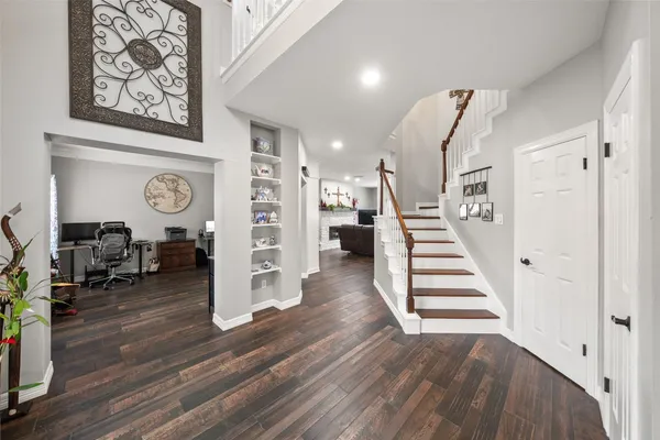 a view of entryway and hall with wooden floor