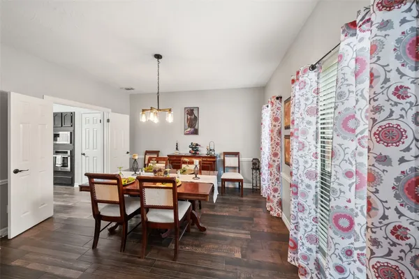 a dining room with furniture and wooden floor