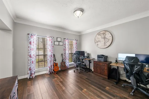 a view of a workspace with furniture and a window
