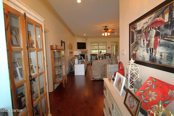a kitchen with stainless steel appliances granite countertop a sink a stove and a refrigerator with wooden cabinets