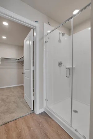 a bathroom with a glass shower door