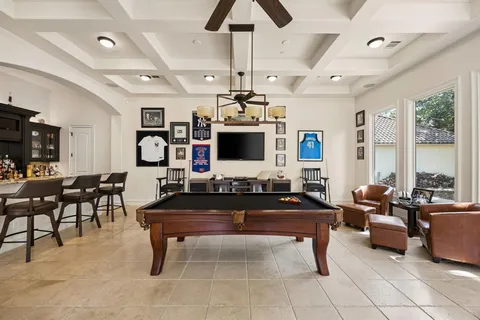 a room with lots of furniture and large windows