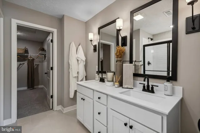 a bathroom with a double vanity sink mirror and double