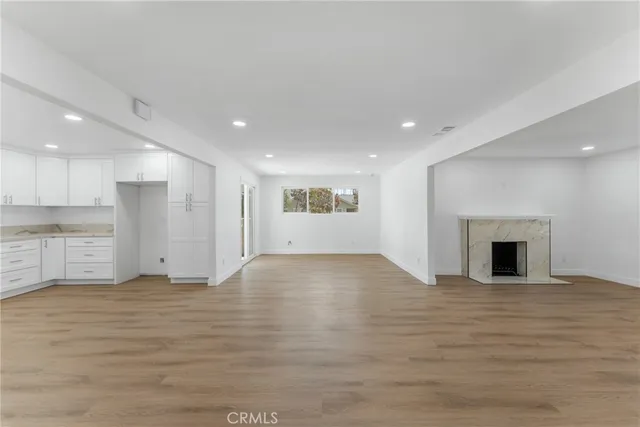 a view of an empty room with a kitchen