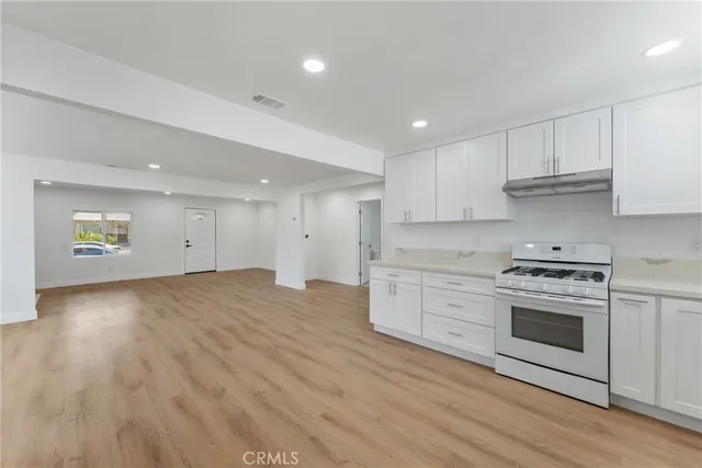 a kitchen with granite countertop a stove and a sink