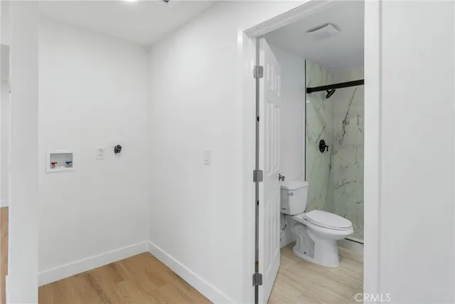 a bathroom with a granite countertop toilet and a shower