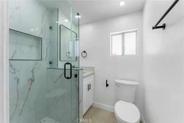 a bathroom with a toilet and a shower