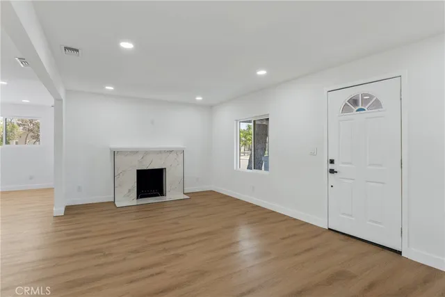wooden floor in an empty room with a window