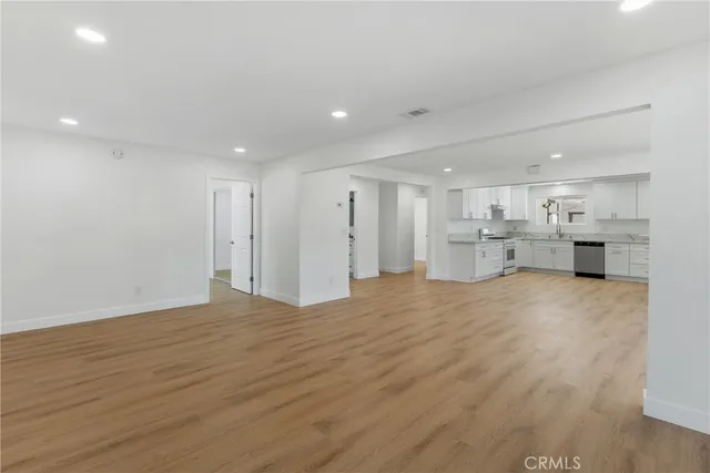 a view of kitchen with refrigerator stove and a cabinets